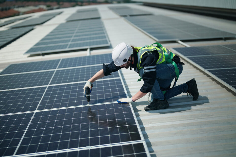 Professional worker installing solar panels on the roof. enginee