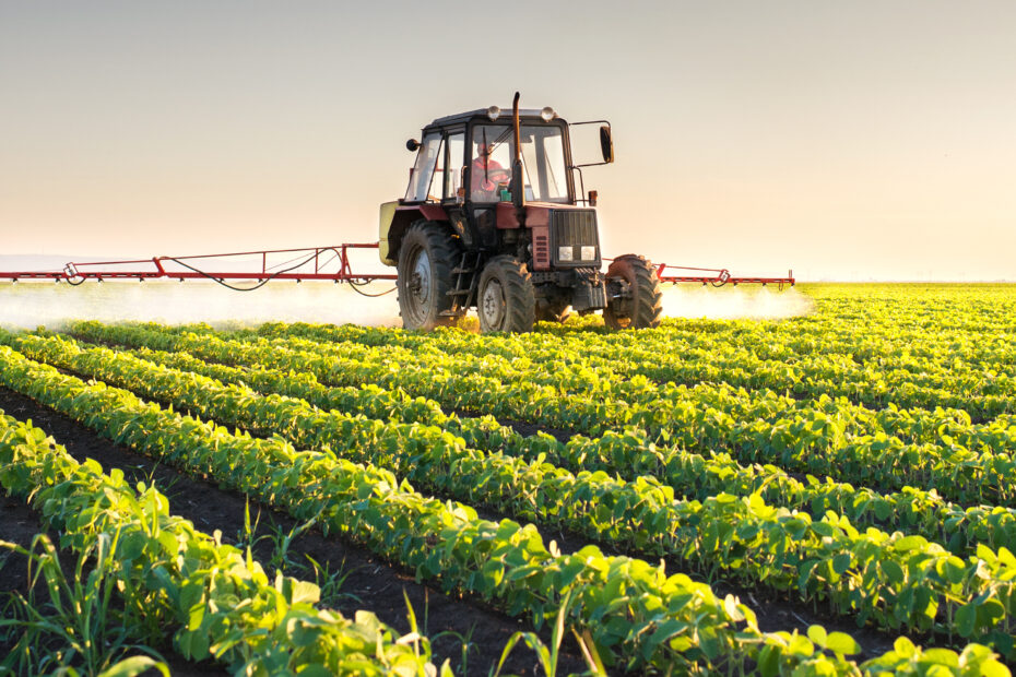 Tractor spraying soybean