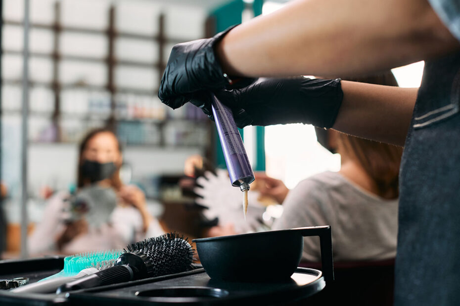 Close-up of hairdresser prepares color for hair dyeing at the salon.